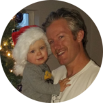Child with Santa and parent during holiday event
