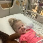 Child in hospital bed supported by Give Hope Nevada